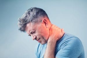 Young man suffering from neck pain