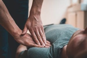 A chiropractor for shoulder pain in Mechanicsburg, PA applying pressure to a client’s joints