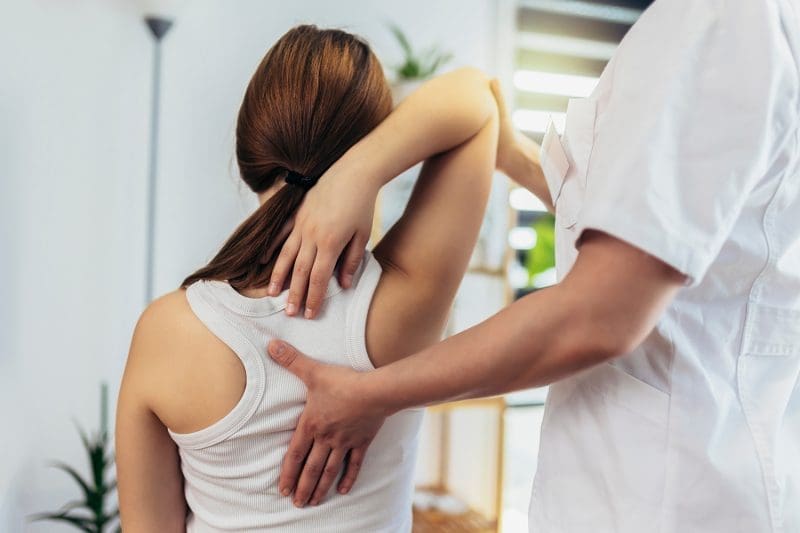 Assessing patient for back adjustment.